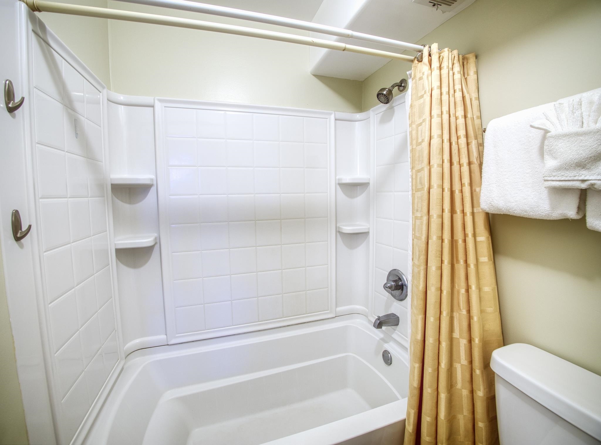 3823 Lower Honoapiilani Road, Unit 311 Lahaina, HI 96761 - Photo 8 of 20 a bathroom with a shower curtain and a toilet