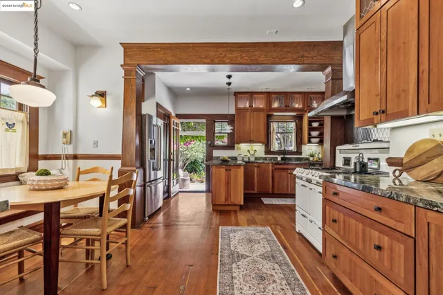 a kitchen with stainless steel appliances granite countertop a stove a refrigerator and cabinets