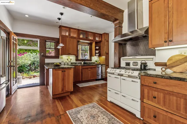 a kitchen with stainless steel appliances granite countertop a refrigerator and a sink