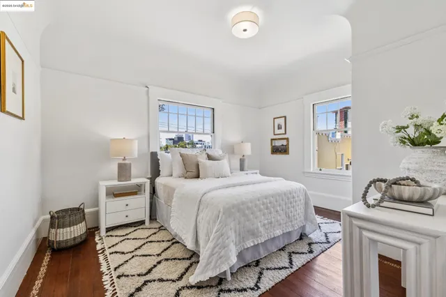 a bedroom with two beds and painting on the wall