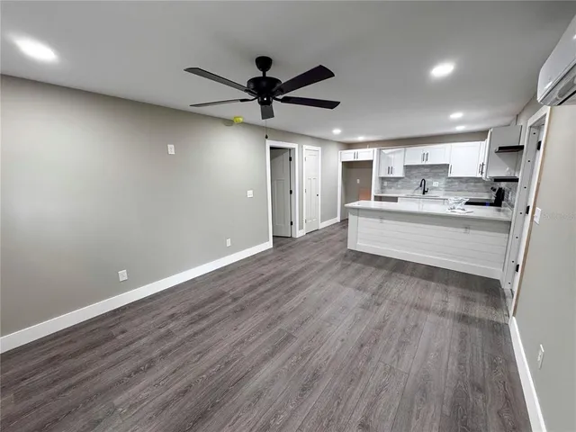 a view of a kitchen with a sink and wooden floor