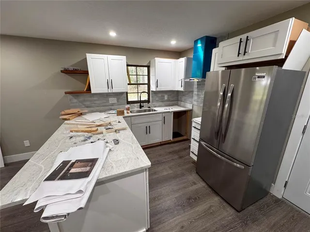 a kitchen with a refrigerator sink and stove