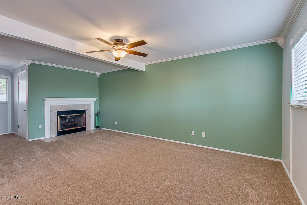 3311 East Bloomfield Road Phoenix, AZ 85032 - Photo 12 of 46 an empty room with windows and fireplace