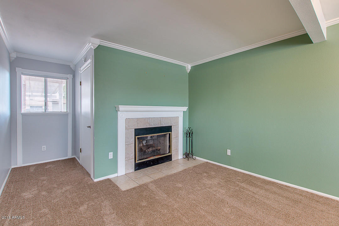 3311 East Bloomfield Road Phoenix, AZ 85032 - Photo 13 of 46 an empty room with a fireplace and window
