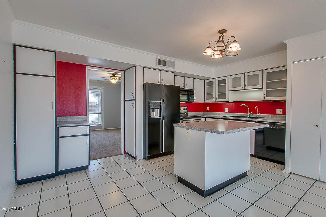 3311 East Bloomfield Road Phoenix, AZ 85032 - Photo 14 of 46 a kitchen with stainless steel appliances granite countertop a refrigerator and a stove