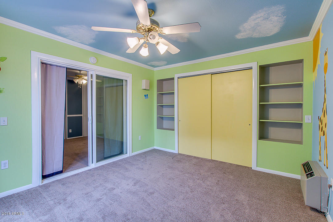 3311 East Bloomfield Road Phoenix, AZ 85032 - Photo 24 of 46 a view of an empty room with a window and kitchen view