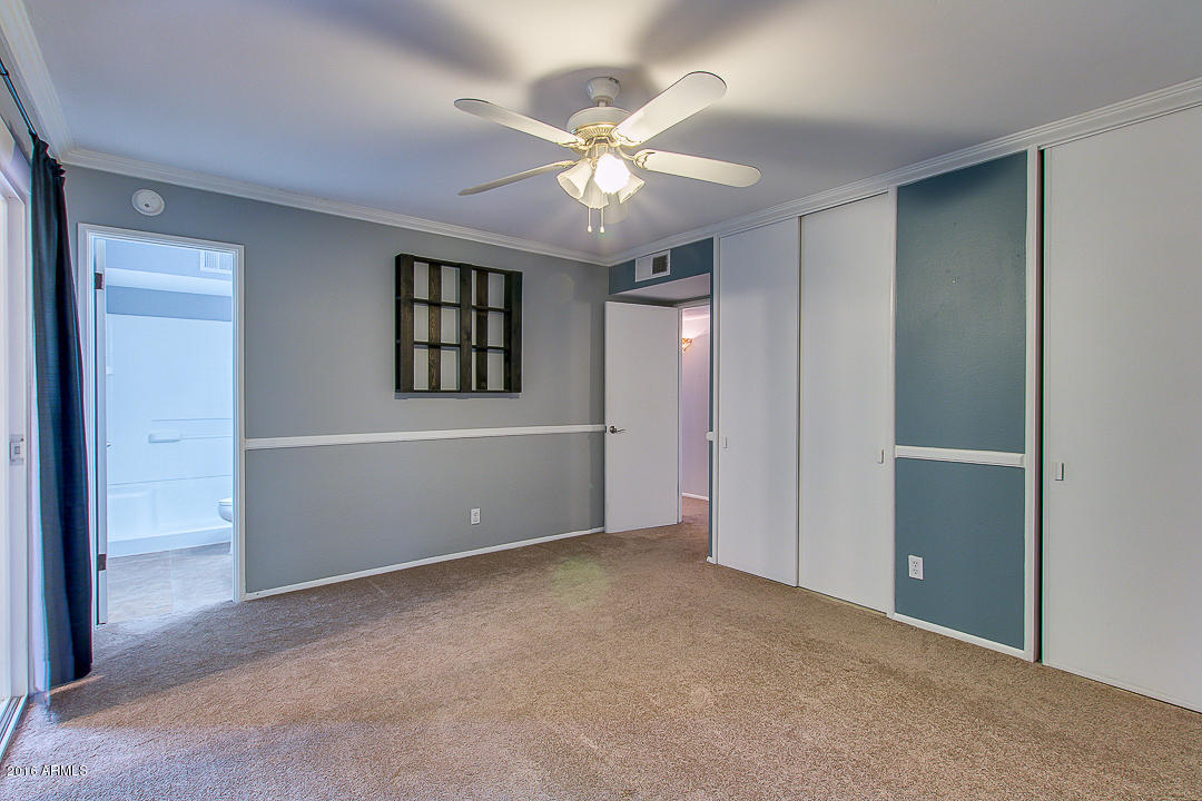 3311 East Bloomfield Road Phoenix, AZ 85032 - Photo 28 of 46 a view of an empty room with a ceiling fan and window