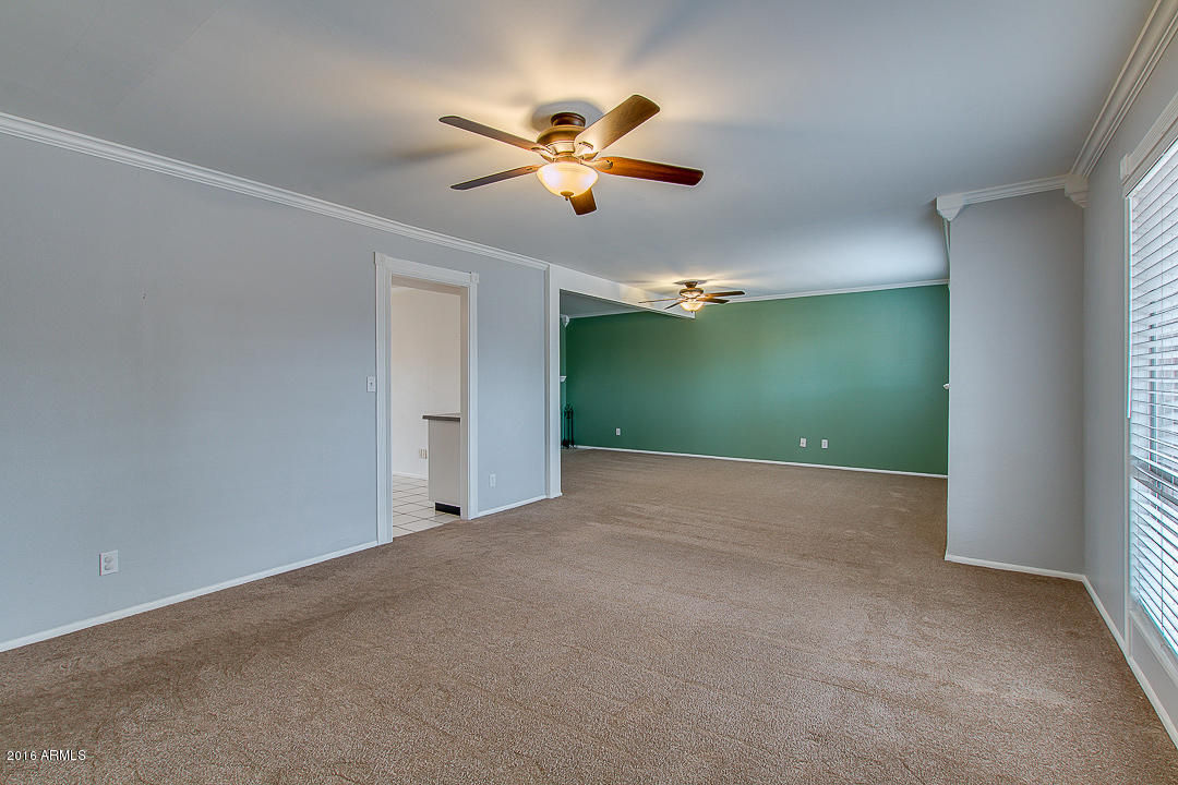 3311 East Bloomfield Road Phoenix, AZ 85032 - Photo 6 of 46 a view of a livingroom with a ceiling fan and window