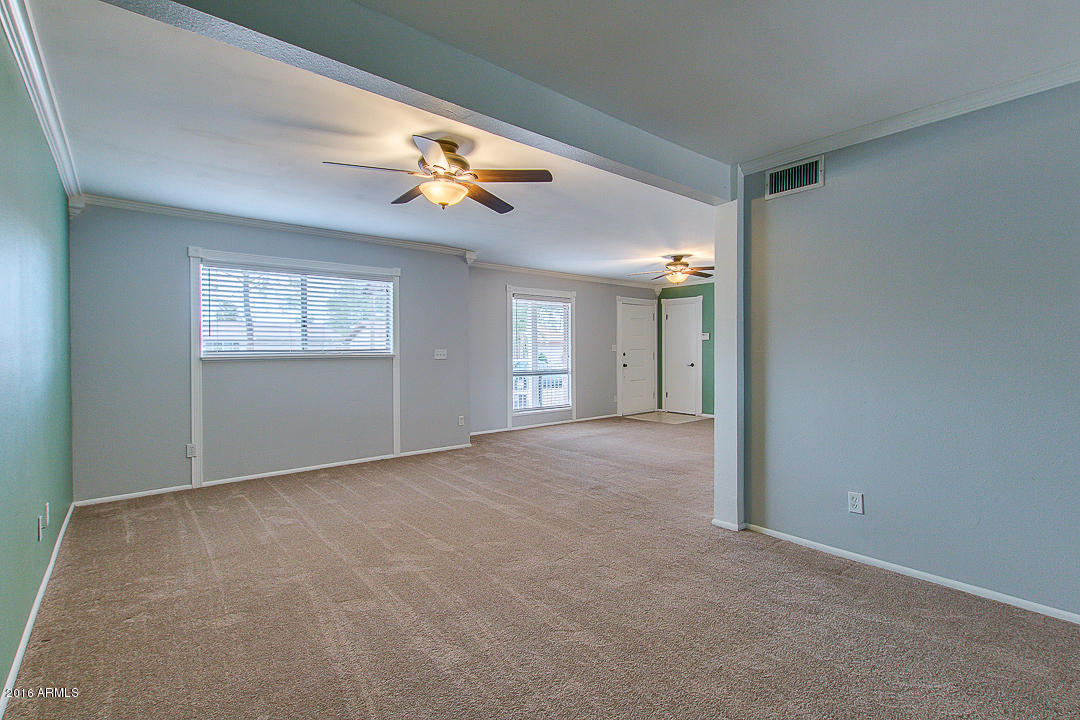 3311 East Bloomfield Road Phoenix, AZ 85032 - Photo 10 of 46 an empty room with windows and cabinet