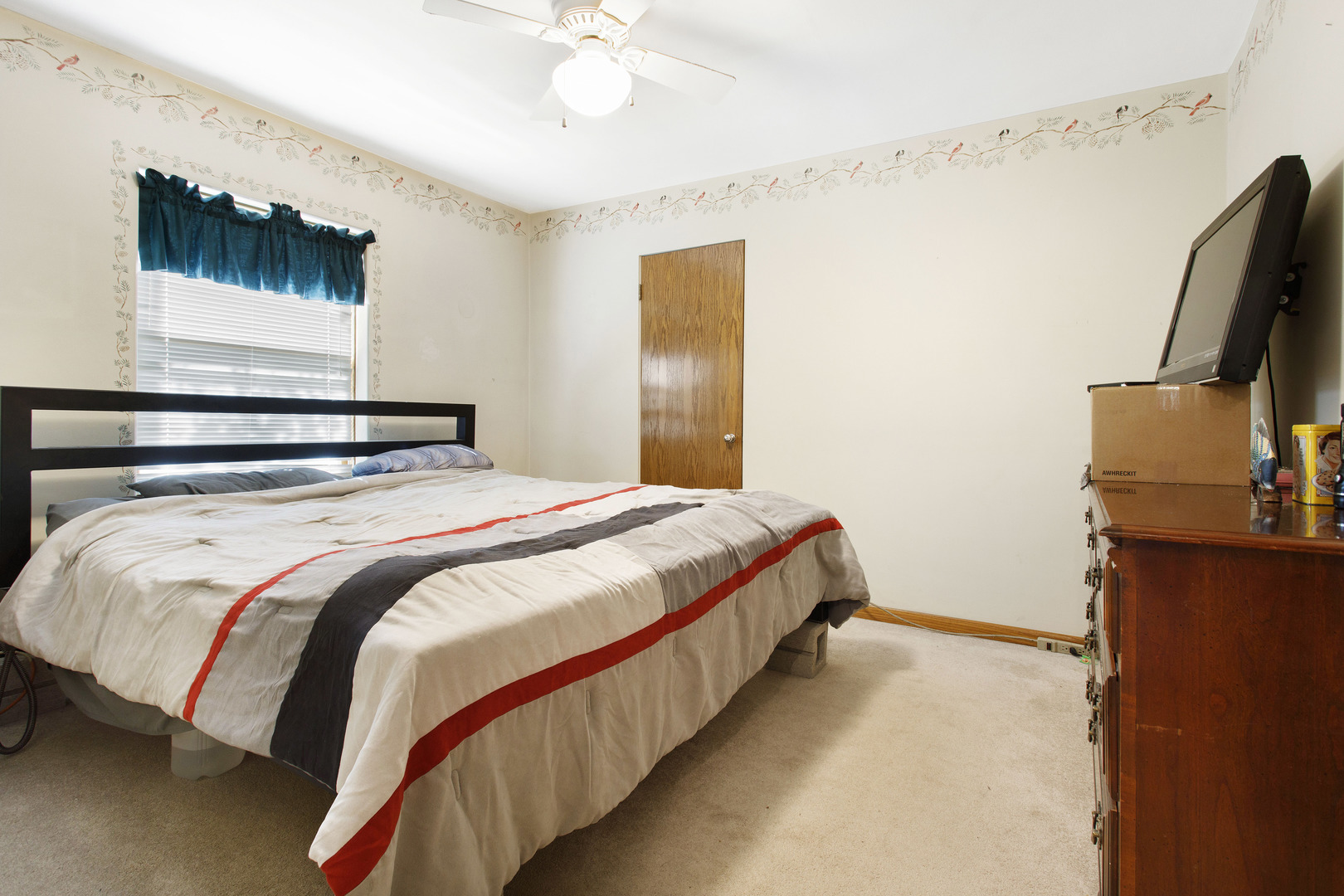 21517 Dunham Road Harvard, IL 60033 - Photo 12 of 36 a bedroom with a bed and a flat tv screen on the dresser
