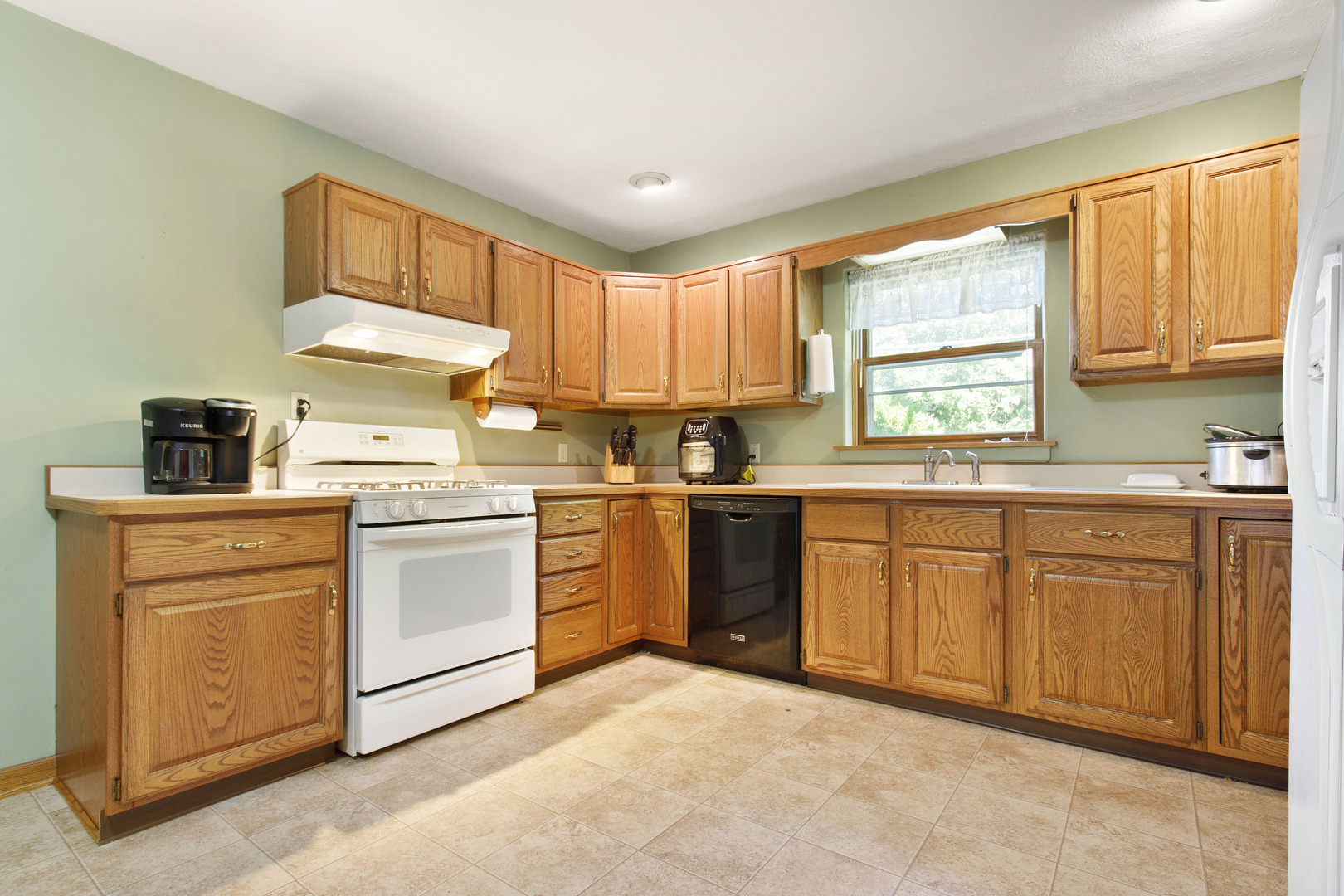 21517 Dunham Road Harvard, IL 60033 - Photo 3 of 36 a kitchen with granite countertop a sink cabinets stainless steel appliances and a window