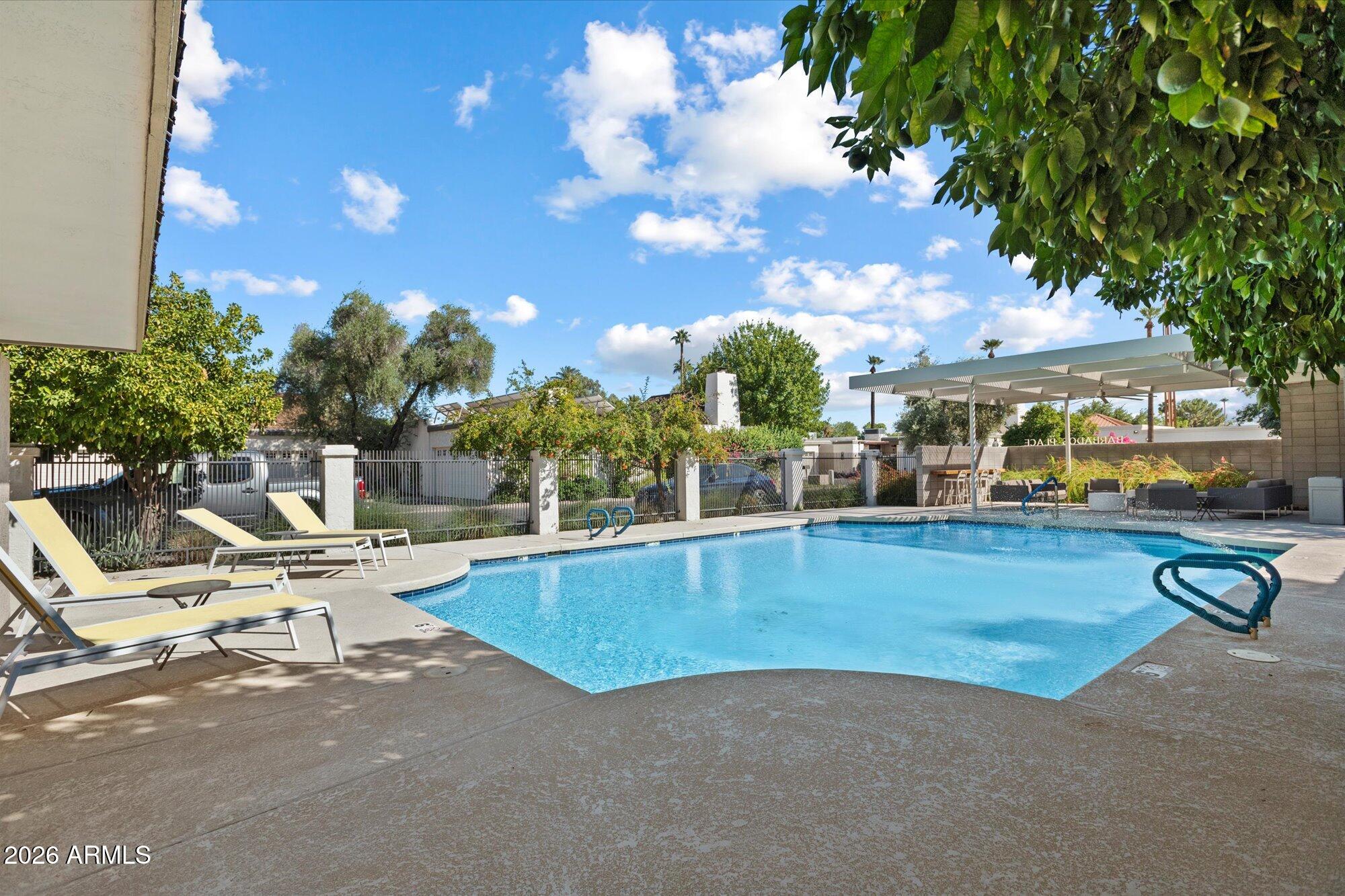 7005 North Barbados Place Phoenix, AZ 85021 - Photo 33 of 42 a view of a swimming pool with outdoor seating and a patio