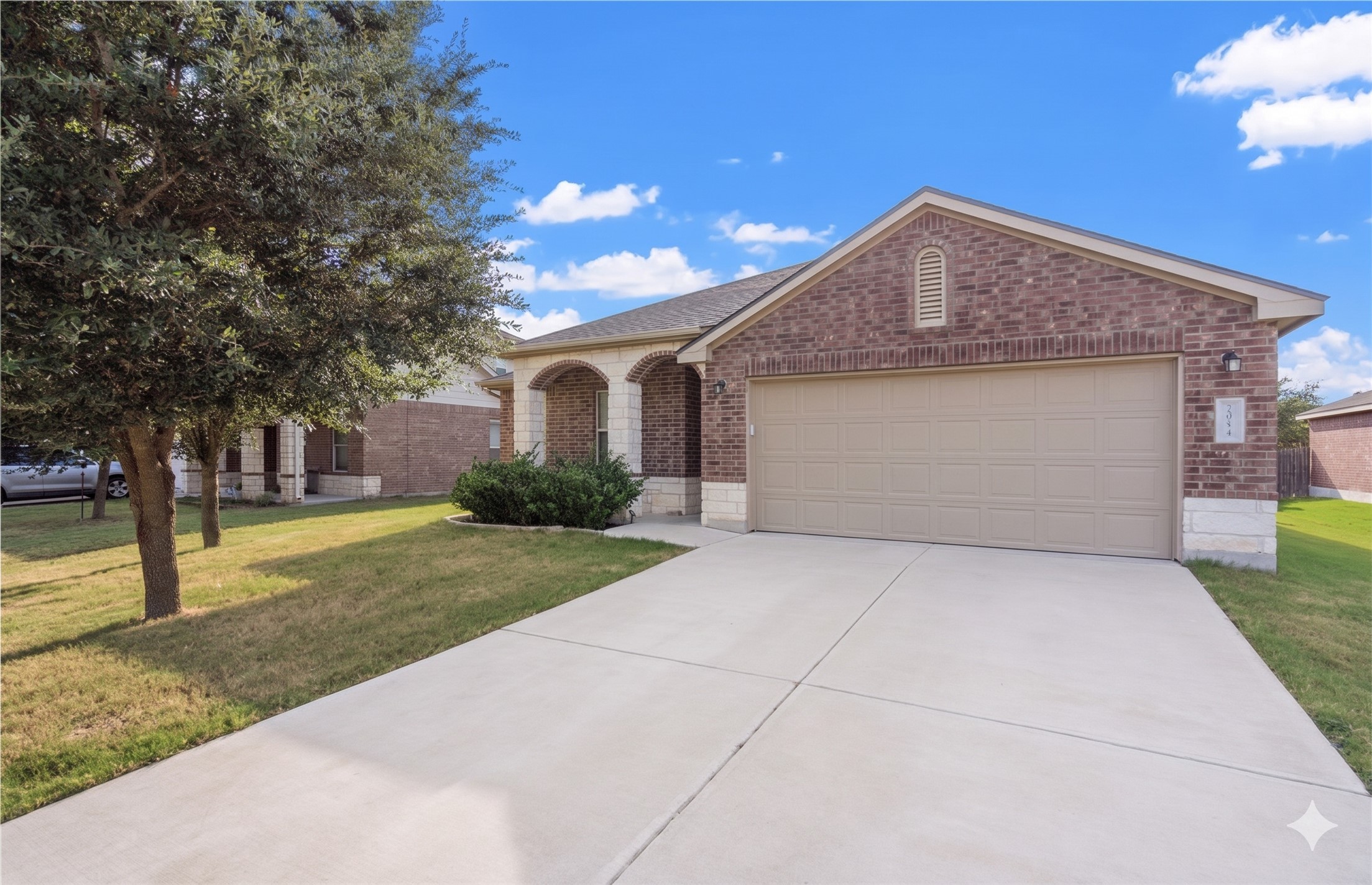 20224 Merlin Falcon Trail Pflugerville, TX 78660 - Photo 39 of 40 A classic brick exterior with stone accents and a welcoming arched entry awaits.