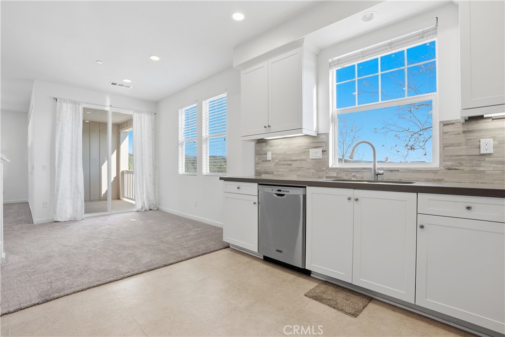 179 Patria Rancho Mission Viejo, CA 92694 - Photo 11 of 75 a kitchen with granite countertop a sink and cabinets