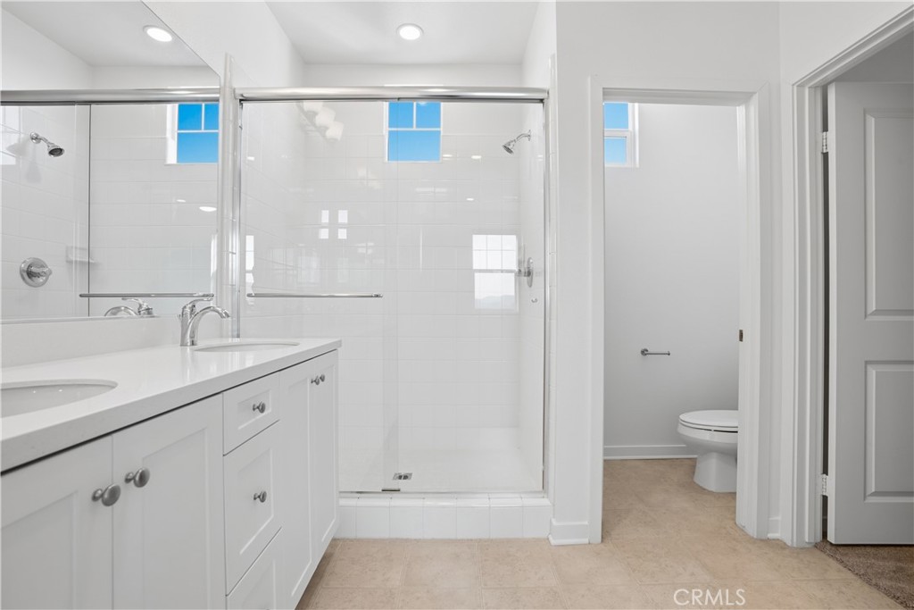 179 Patria Rancho Mission Viejo, CA 92694 - Photo 25 of 75 a bathroom with a granite countertop sink a toilet and shower