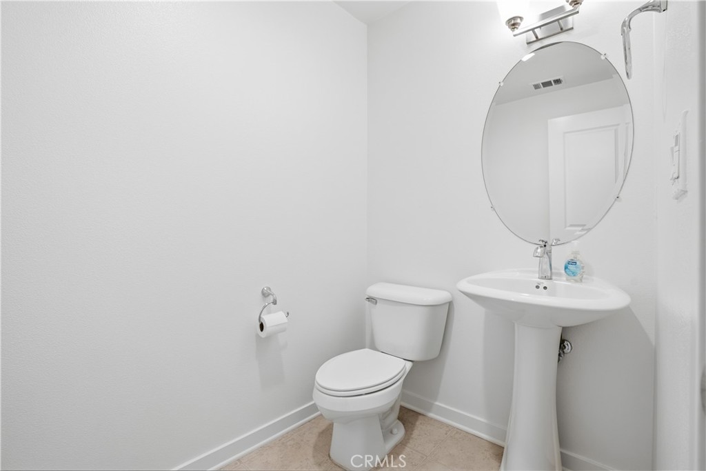 179 Patria Rancho Mission Viejo, CA 92694 - Photo 30 of 75 a bathroom with a toilet a sink and mirror