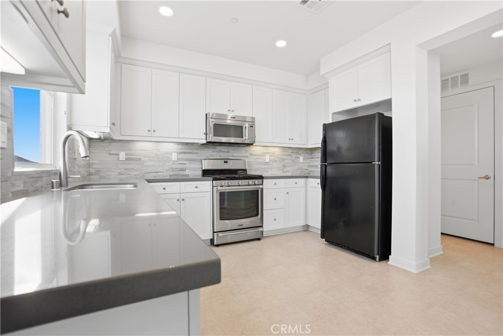 179 Patria Rancho Mission Viejo, CA 92694 - Photo 8 of 75 a kitchen with stainless steel appliances granite countertop a refrigerator sink and stove