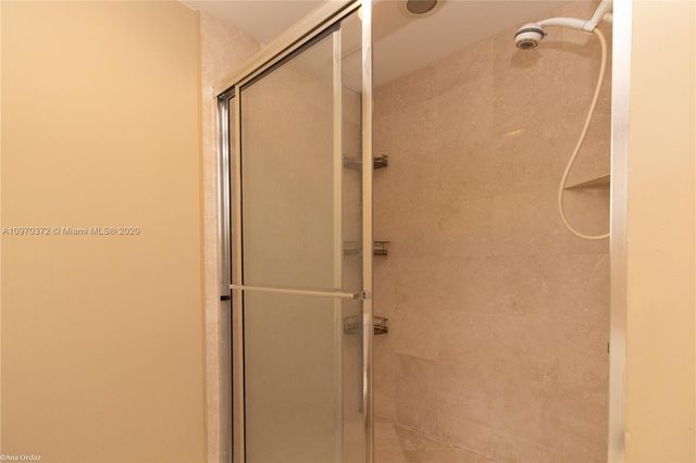 a bathroom with a glass shower door