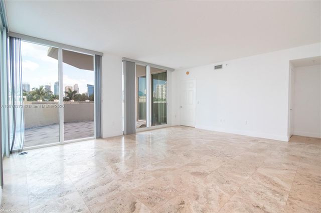 a view of an empty room with glass door