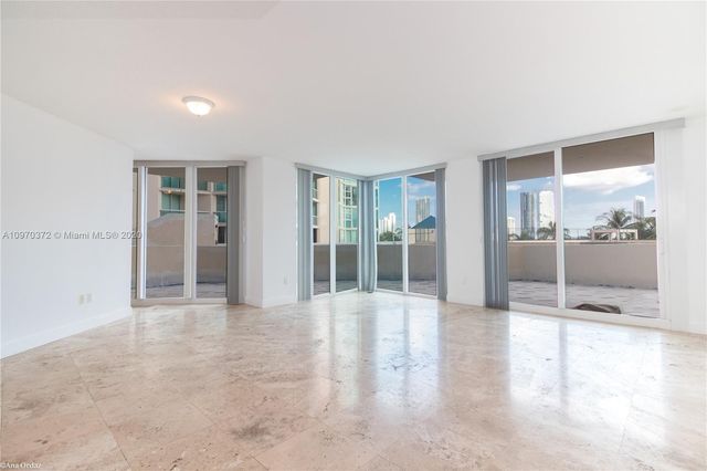 an empty room with glass door and shower