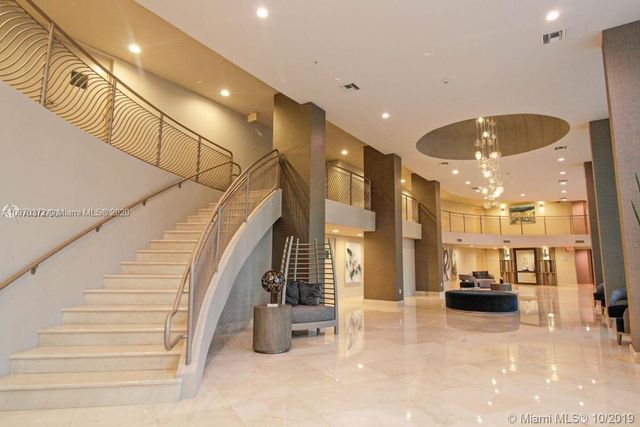 a view of entryway and hall with stainless steel appliances
