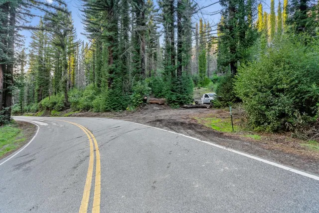 a view of a road with a bench in the background