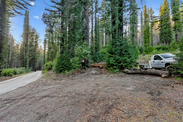 a view of a street with parked cars