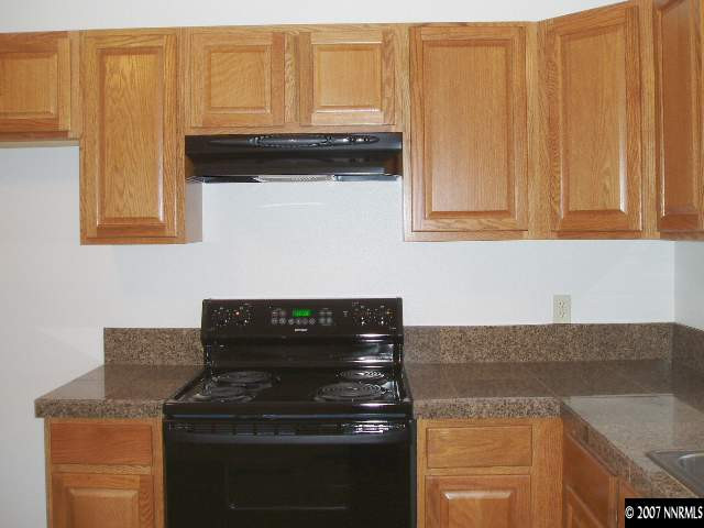 2140 Windsor Way Reno, NV 89503 - Photo 7 of 8 a kitchen with granite countertop cabinets and a stove top oven