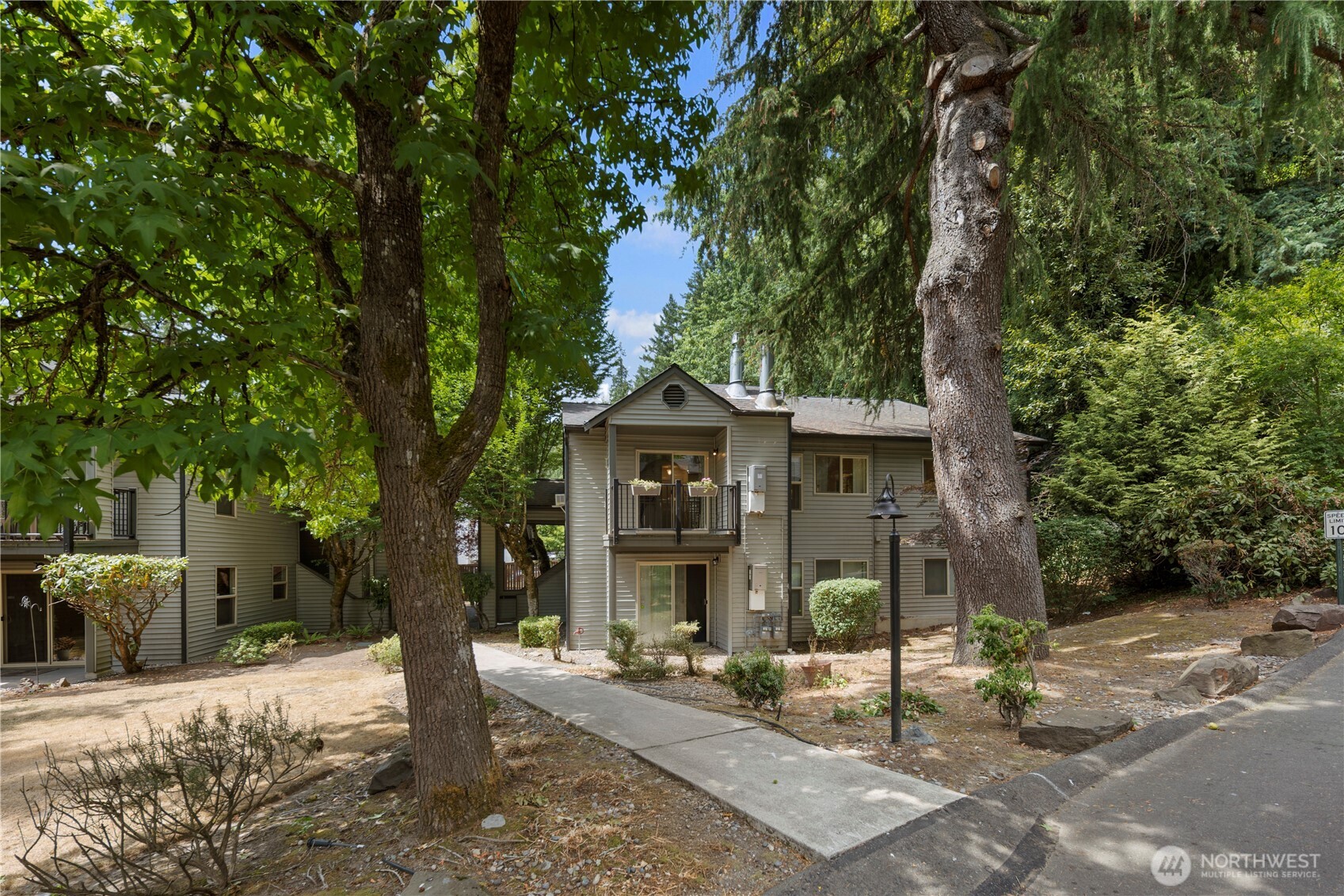 9805 Avondale Road Northeast, Unit L238 Redmond, WA 98052 - Photo 1 of 19 a front view of a house with garden