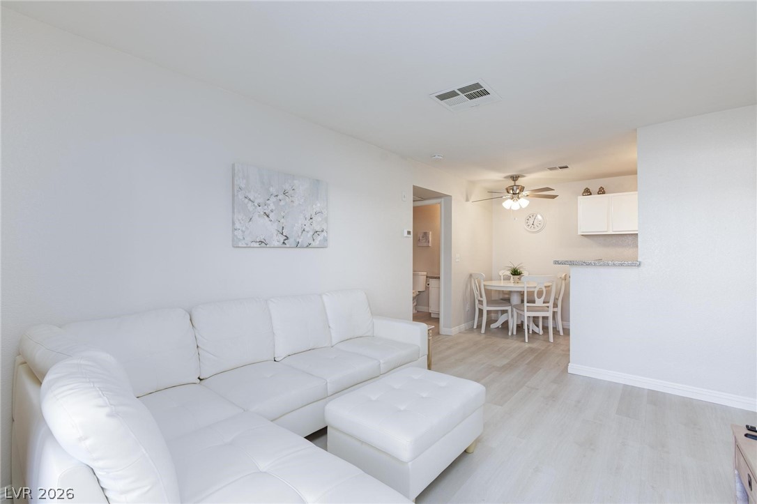 5171 South Lindell Road, Unit 103 Las Vegas, NV 89118 - Photo 8 of 24 A luminous living area seamlessly flows into a well-appointed dining space.