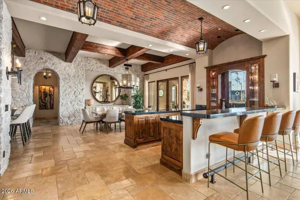 a dining room with furniture a chandelier and a rug