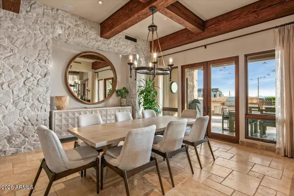 a dining hall with stainless steel appliances granite countertop a sink and a stove