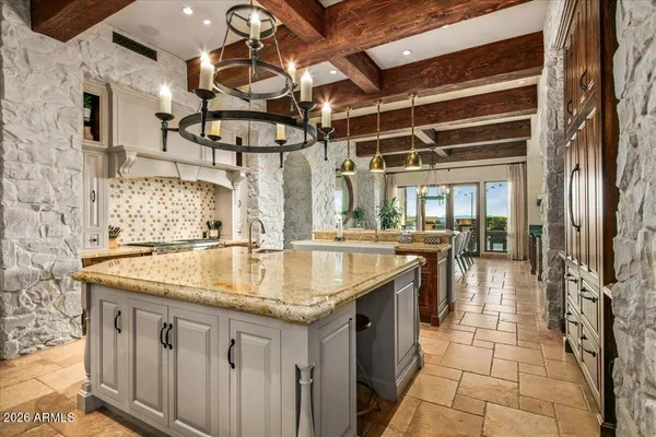 a bathroom with a granite countertop sink a mirror and shower