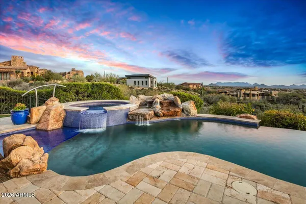 a living room with furniture lots of books and a book shelf