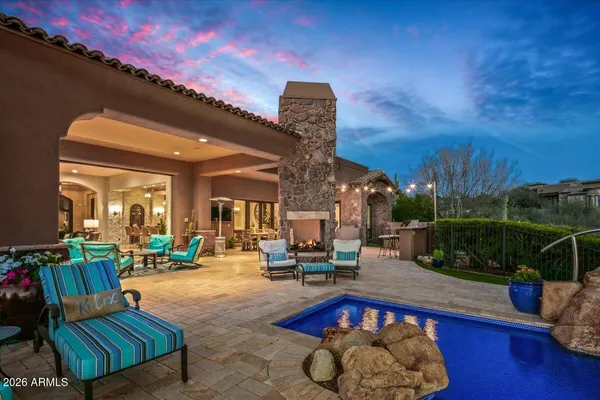 a bed sitting in a spacious bedroom next to a window
