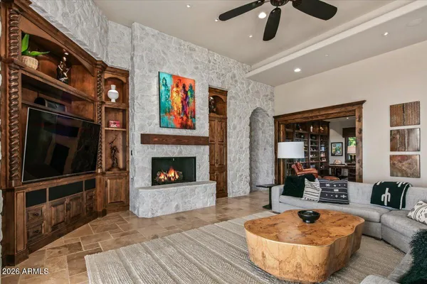 a large kitchen with kitchen island a large window a sink and stainless steel appliances