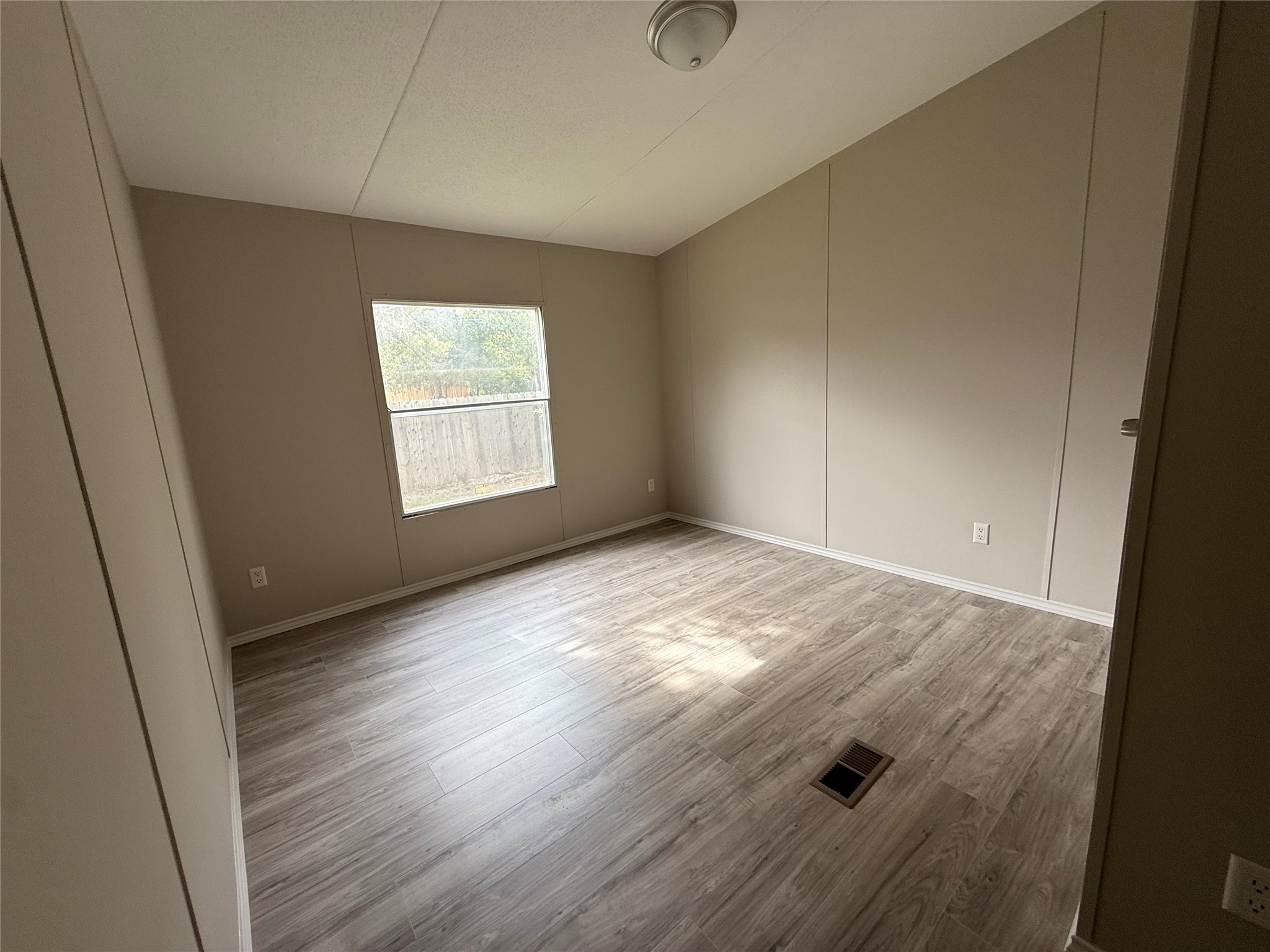 20701 Liveoak Lane Manor, TX 78653 - Photo 11 of 31 Unfurnished room with wood finished floors and baseboards