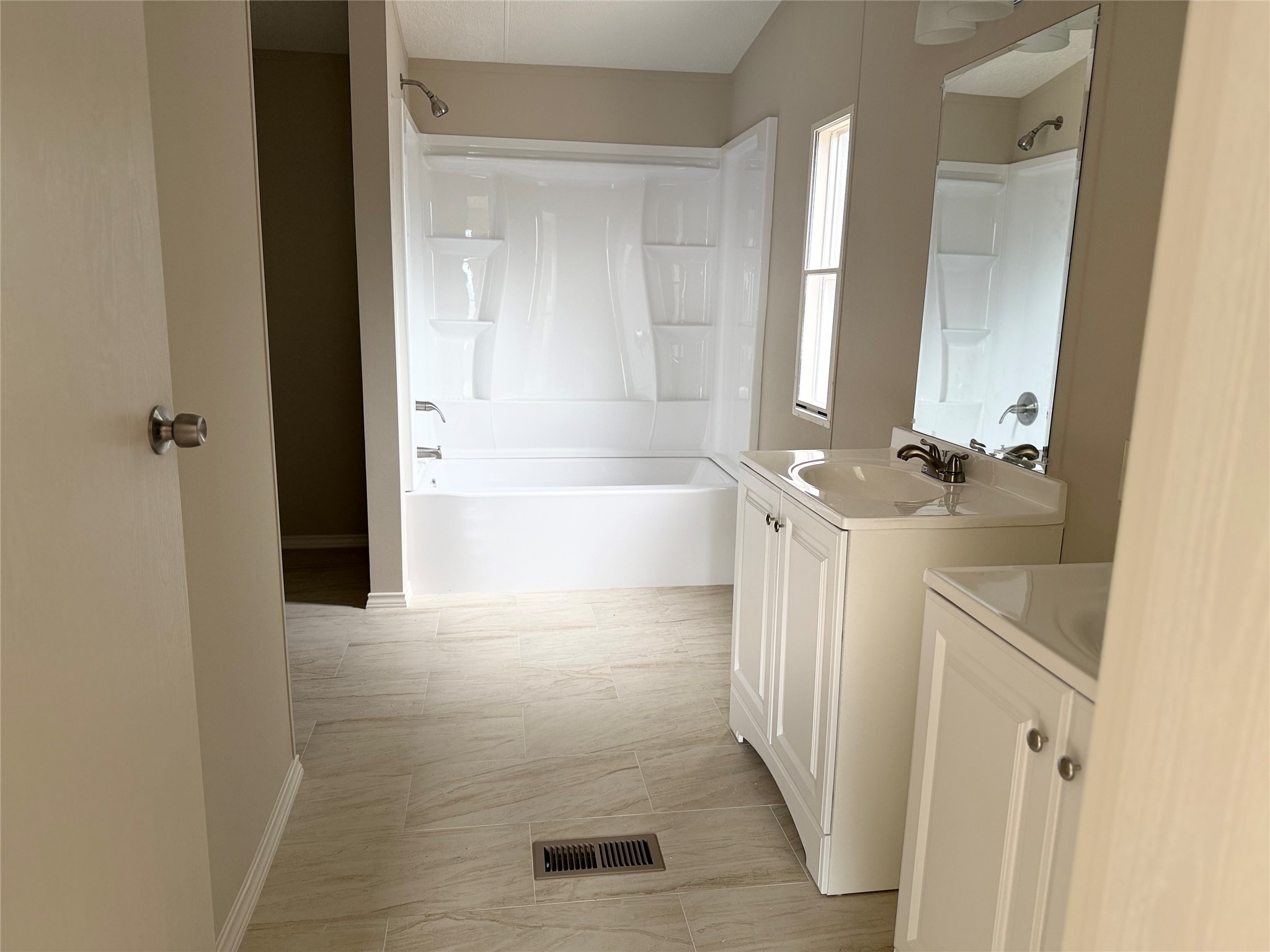20701 Liveoak Lane Manor, TX 78653 - Photo 15 of 31 Bathroom with two vanities and bathtub / shower combination
