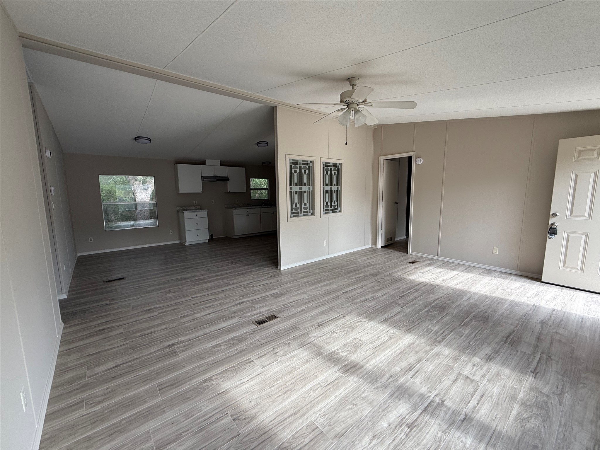 20701 Liveoak Lane Manor, TX 78653 - Photo 18 of 31 Unfurnished living room with wood finished floors and a ceiling fan