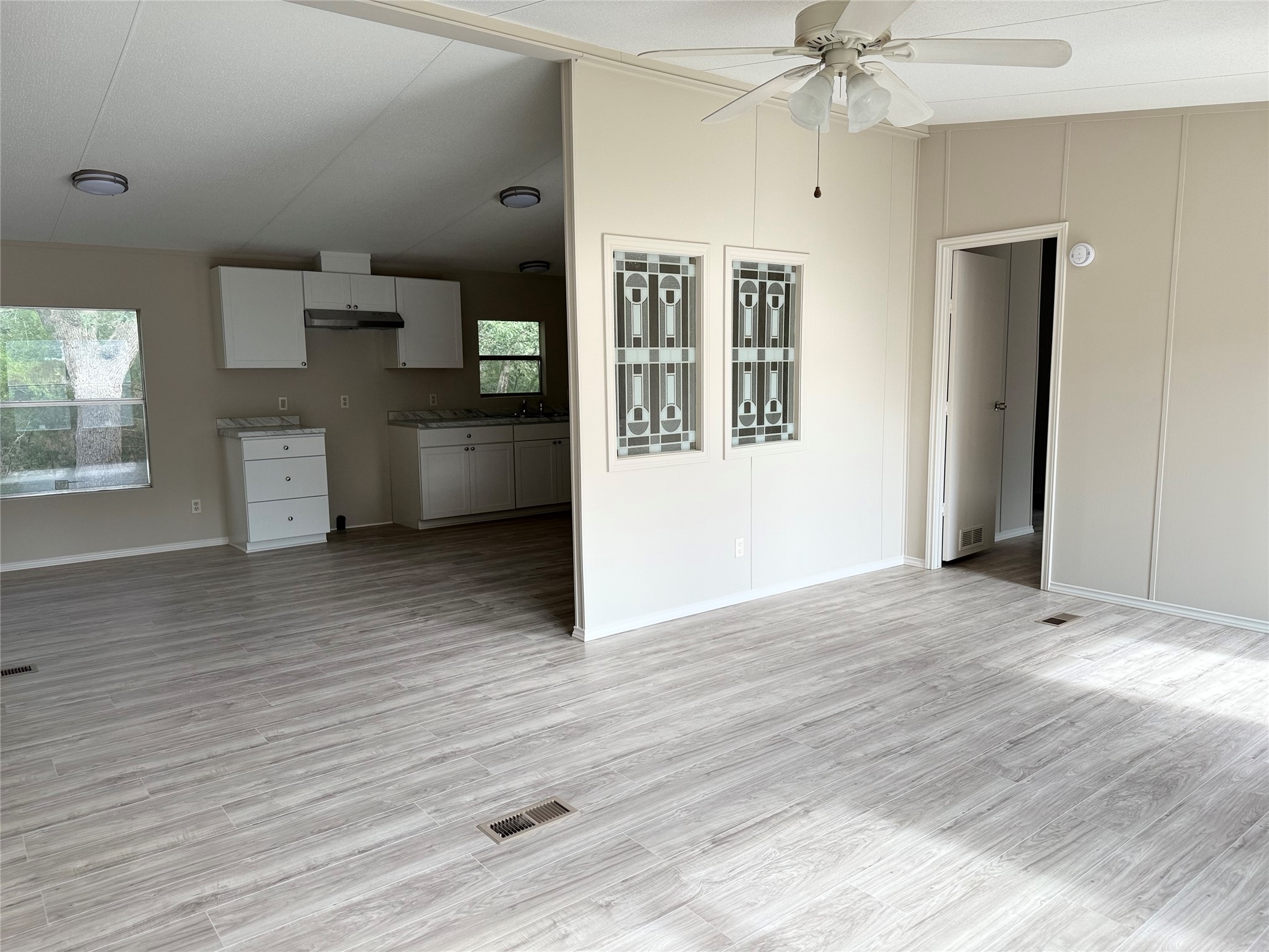 20701 Liveoak Lane Manor, TX 78653 - Photo 19 of 31 Unfurnished living room featuring light wood-type flooring, vaulted ceiling, and ceiling fan