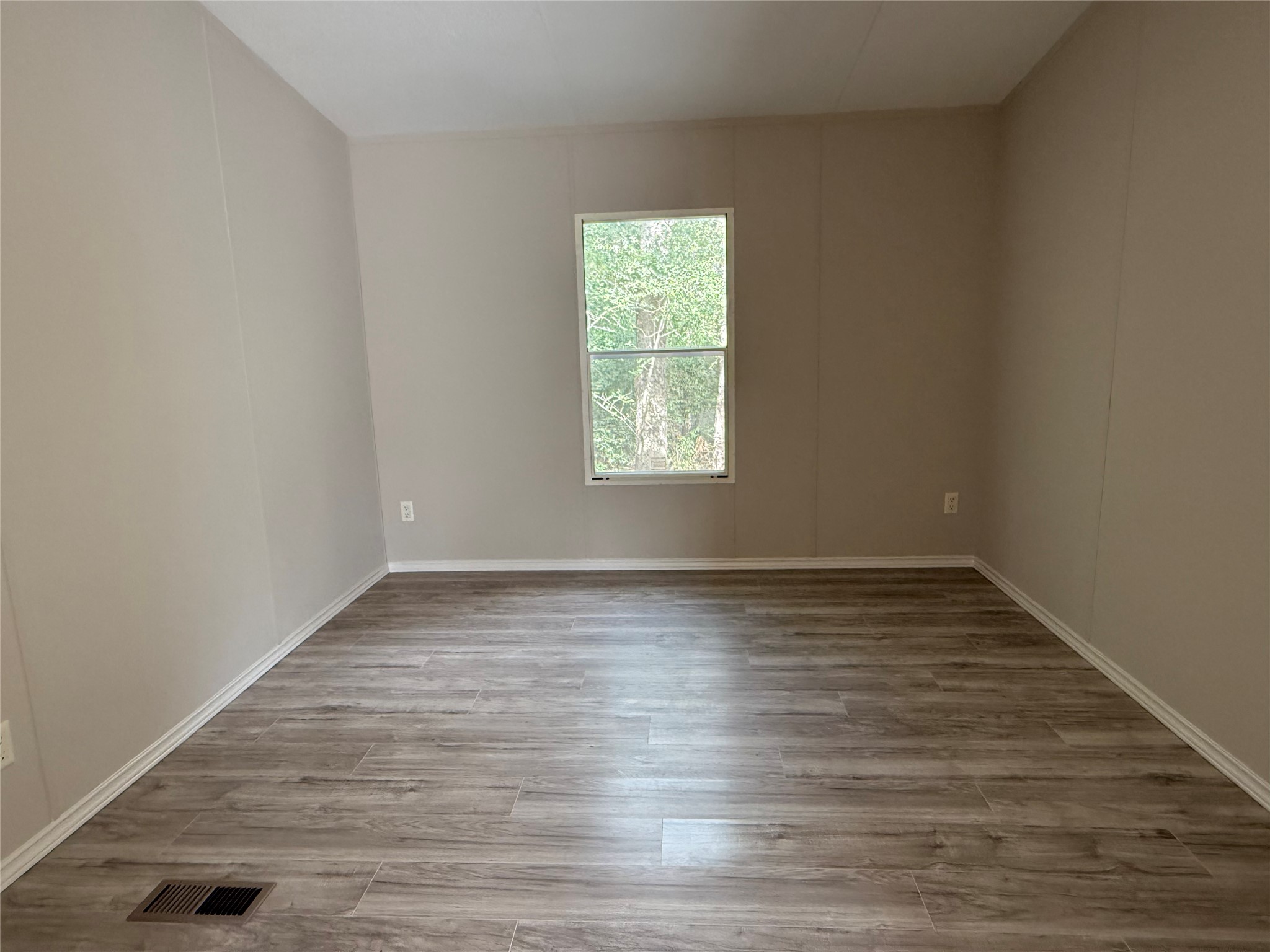 20701 Liveoak Lane Manor, TX 78653 - Photo 25 of 31 Empty room featuring light wood-style floors and baseboards