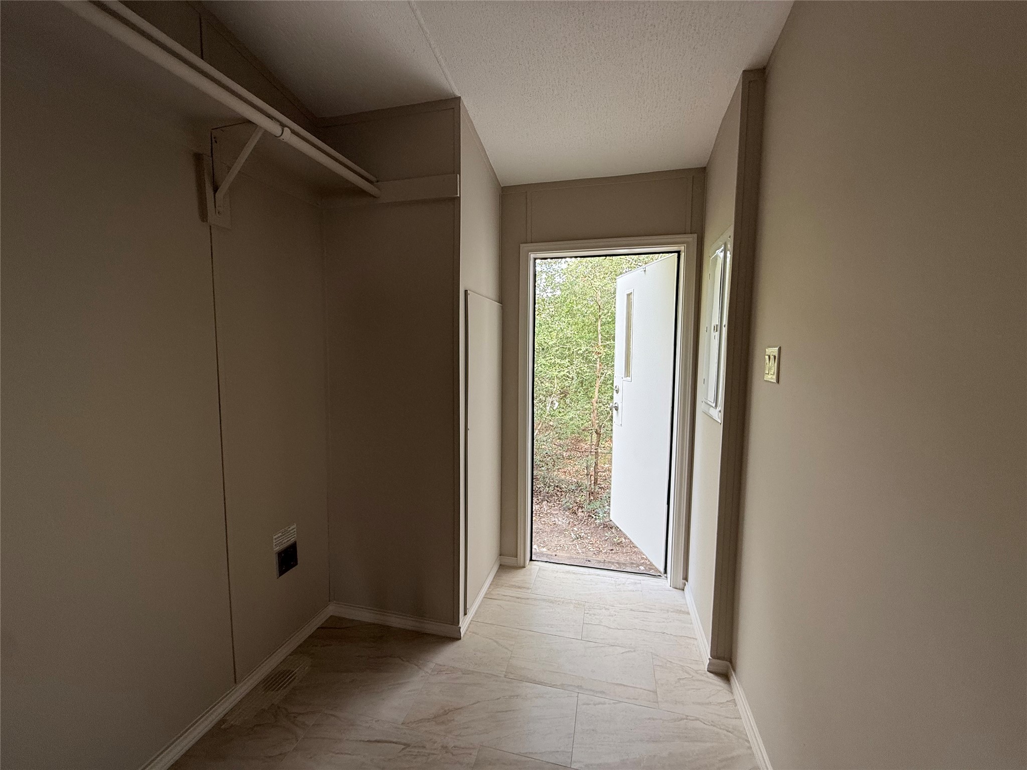 20701 Liveoak Lane Manor, TX 78653 - Photo 5 of 31 Doorway with a textured ceiling and baseboards