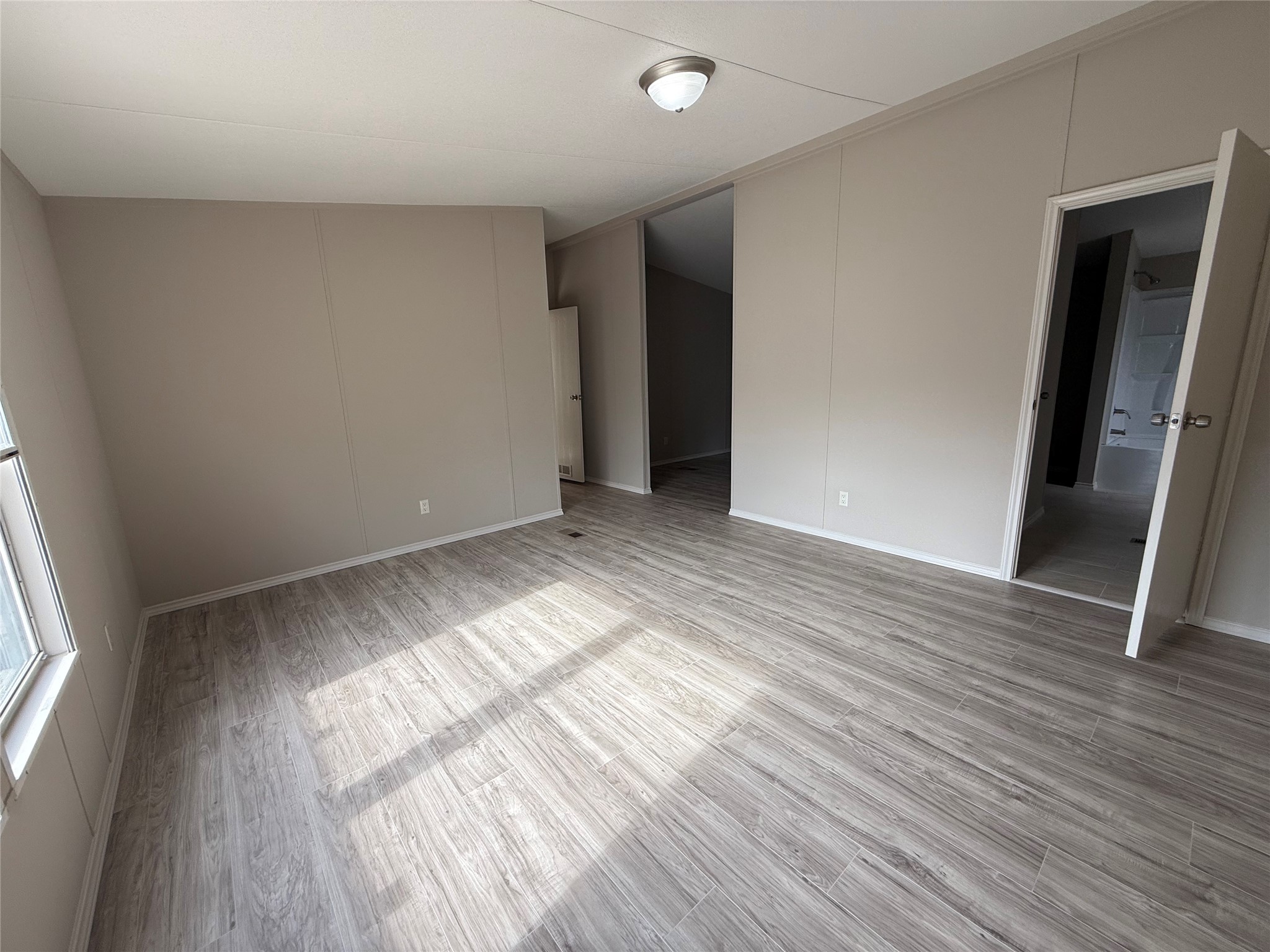 20701 Liveoak Lane Manor, TX 78653 - Photo 9 of 31 Unfurnished room with light wood-style floors and a decorative wall