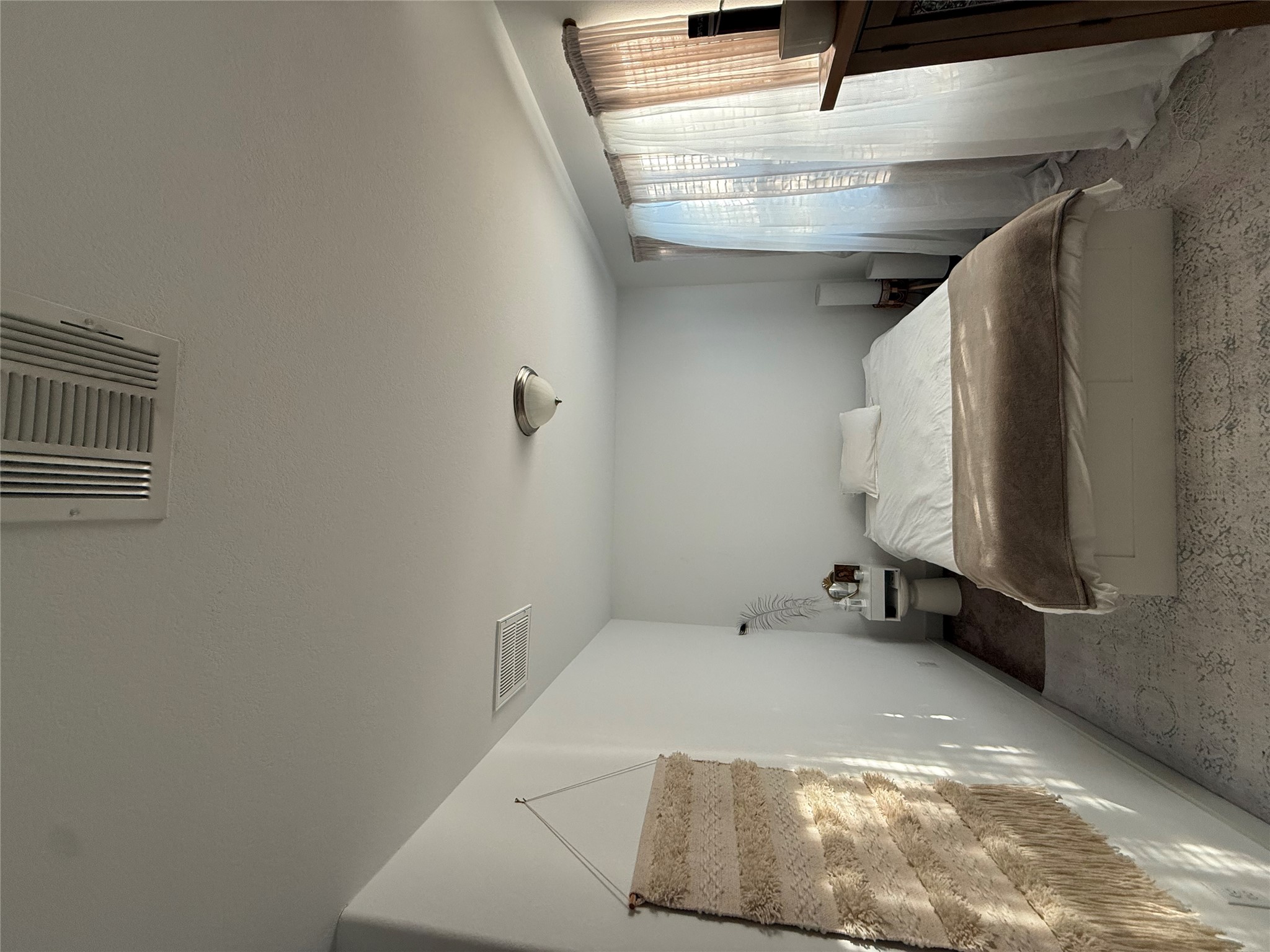 2214 Capulet Street Austin, TX 78741 - Photo 16 of 33 a bedroom with a bed and a window