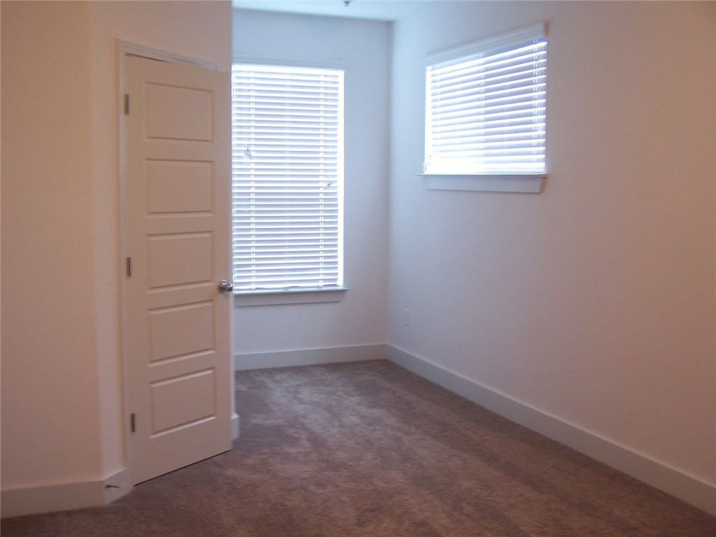 2214 Capulet Street Austin, TX 78741 - Photo 24 of 33 an empty room with windows and closet