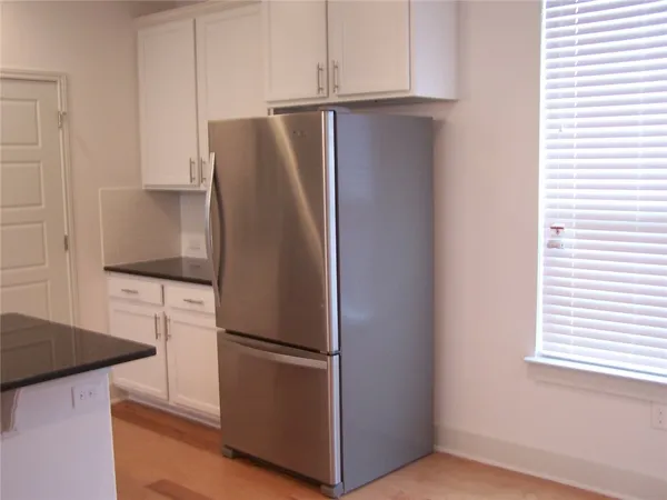 a kitchen with stainless steel appliances granite countertop a refrigerator and a stove