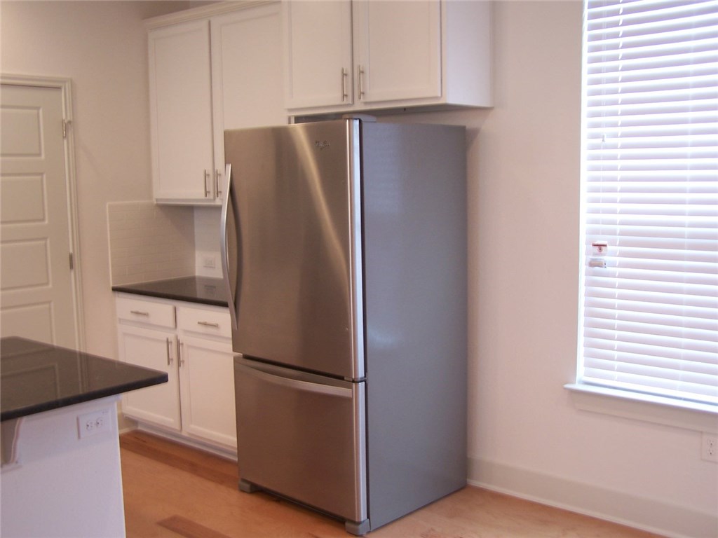 2214 Capulet Street Austin, TX 78741 - Photo 4 of 33 a kitchen with stainless steel appliances granite countertop a refrigerator and a stove
