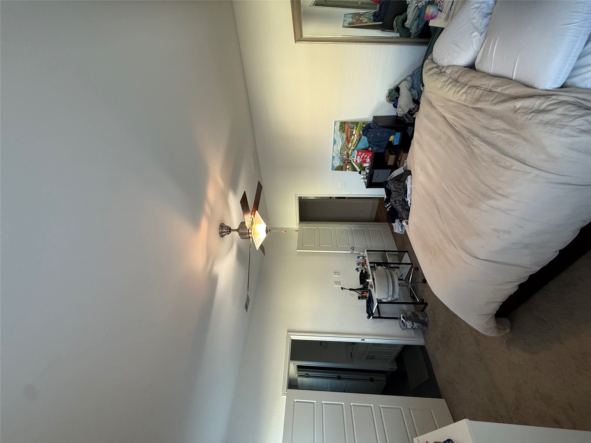 2214 Capulet Street Austin, TX 78741 - Photo 6 of 33 a bedroom with a bed and a chandelier