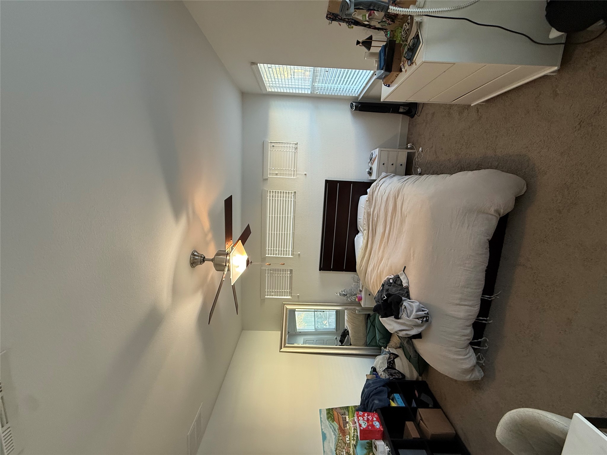 2214 Capulet Street Austin, TX 78741 - Photo 7 of 33 a bedroom with bed a couch and a chandelier