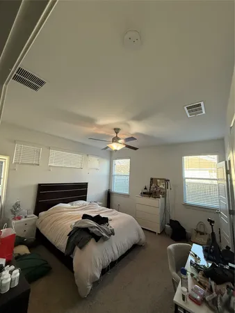 a bedroom with bed couch and window